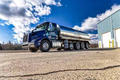 Navy Water Transport tanker with a stainless steel tank parked in the yard