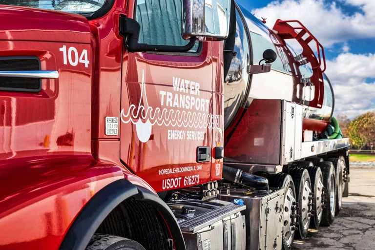 Door of a red Water Transport Energy Services truck with unit number and USDOT number