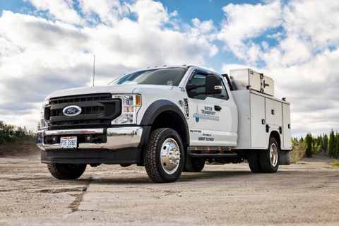 White Ford service truck with a utility body for Water Transport