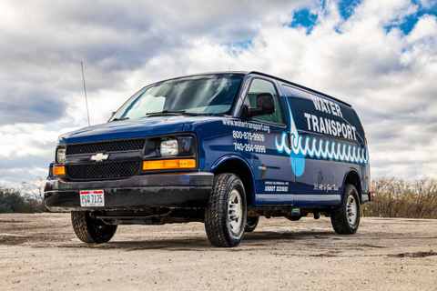 Navy Chevrolet van with Water Transport graphics and phone numbers