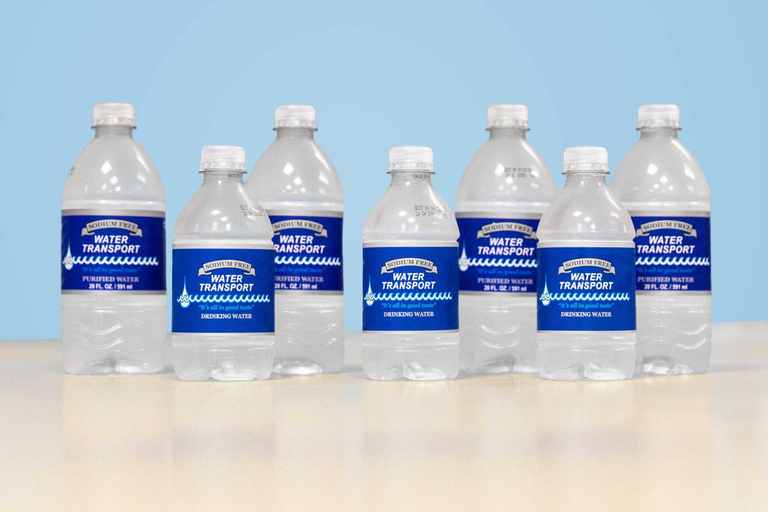 Row of Water Transport half-liter bottles with blue labels